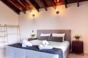 a bedroom with a bed with two stuffed animals on it at Villa Sun Bay in Eilat +59 photos