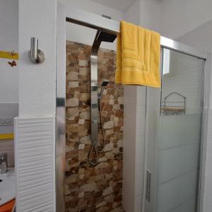 a bathroom with a shower with a yellow towel at TerrazzaPonente in Monte San Pietro