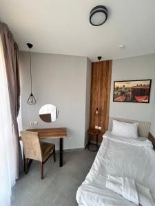 a bedroom with a bed and a desk at Clepsydra Residence in Plovdiv +115 photos