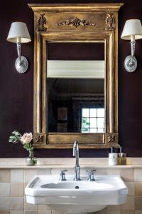a bathroom with a sink and a mirror at Chilston Park Hotel in Maidstone +66 photos