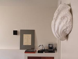 a room with a table with a clock on the wall at Hôtel Nude Paris - Color Vision in Paris