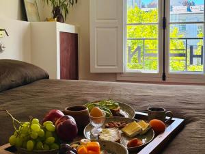 a tray of food on top of a bed at Hôtel Nude Paris - Color Vision in Paris