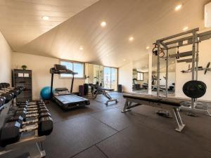 a gym with several treadmills and machines in a room at Jounieh Suites Boutique Hotel in Jounieh