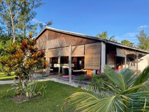 a small house with a wooden facade in a garden at Villa Masoandro in Sainte Marie