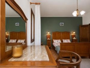 a bedroom with two beds and a table and a chair at Ca'Mia - Rooms in Porto Tolle