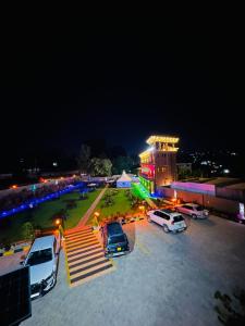 a parking lot with cars parked in front of a building at Rubax motel mbarara in Mbarara
