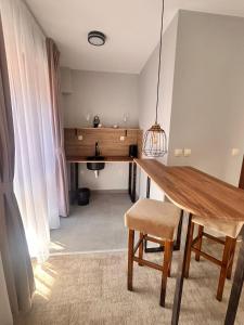 a dining room with a wooden table and a chair at Clepsydra Residence in Plovdiv