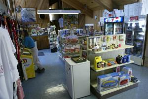 a store with a woman sitting at a counter in a store at Snowflower Camping Resort 16 ft. Yurt 10 in Emigrant Gap