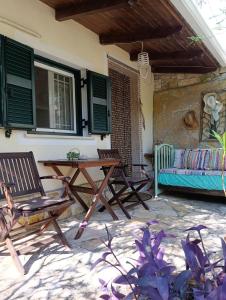 a patio with two chairs and a wooden table at Casa Natasa in Oziás