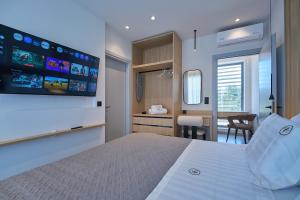 a bedroom with a large bed with a tv on the wall at Bella Terra Natura in Roda +50 photos
