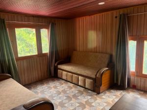 a room with a bench in a room with windows at DELTA Inn HOMESTAY in Khashdhār +17 photos