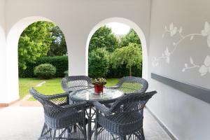 a patio with a table and chairs and a window at Zita Haus in Bük