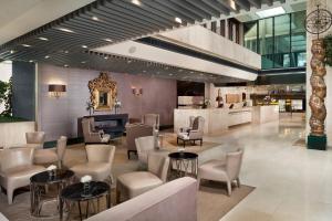 a lobby of a hotel with chairs and tables at Meliá Castilla in Madrid
