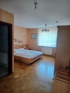 a bedroom with a large bed in a room at Adler Gaststube Hotel Biergarten in Bad Rappenau