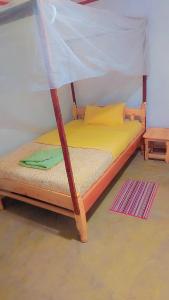 a bed with a canopy in a room at Essie Rovers Camp in Talek