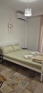 a bedroom with a large green bed in a room at Sea home Asprovalta in Asprovalta