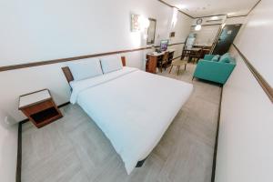 a bedroom with a bed and a dining room at Toyoko Inn Cebu in Cebu City +47 photos