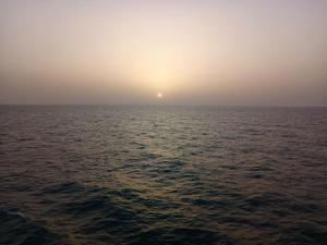 a view of the ocean with the sun in the horizon at SEN-CASA- TOURiSME in Kabadio +10 photos