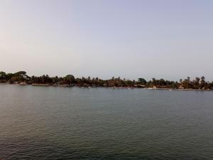 a large body of water with trees in the background at SEN-CASA- TOURiSME in Kabadio