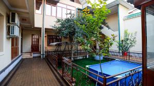 a courtyard of a house with a swimming pool at Family Hotel in Khujand