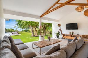 a living room with a couch and a table at Villa Panorama in Nusa Penida