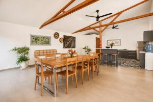 a dining room with a wooden table and chairs at Villa Panorama in Nusa Penida