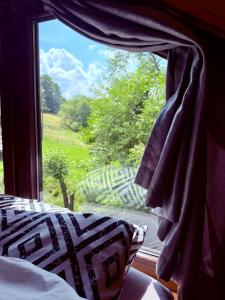 a bedroom with a window looking out at a garden at Stodoła in Nieledwia +35 photos