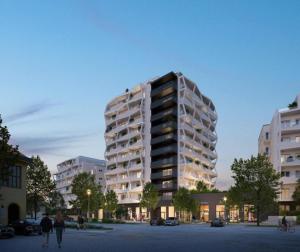 a tall building with people walking in front of it at Apartmán v komplexu Meridiem in Komárov