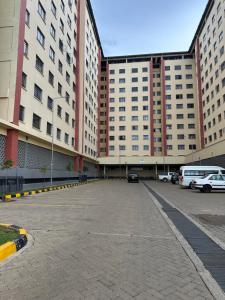 a parking lot in front of a large building at Lucci suites in Kisumu