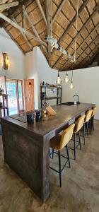 a large wooden table in a room with chairs at Pata Pata House in Marloth Park