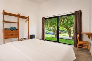 a bedroom with a bed and a large window at Villa Panorama in Nusa Penida +26 photos