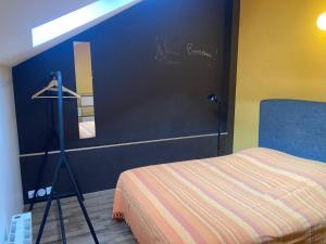 a bedroom with a bed and a mirror on the wall at La Maisonnette in Les Andelys