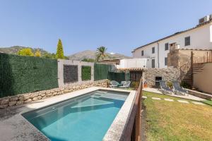 a swimming pool in the backyard of a house at Casa Horta Den Menut in Pollença