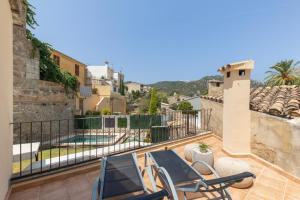 a balcony with chairs and a swimming pool at Casa Horta Den Menut in Pollença