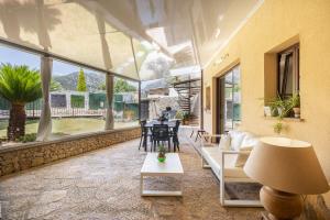 a living room with a couch and a table at Casa Horta Den Menut in Pollença