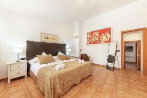 a bedroom with a bed with two towels on it at Casa Horta Den Menut in Pollença +26 photos
