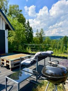 a grill and a b smoker on a deck at Stodoła in Nieledwia
