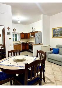 a kitchen and living room with a table and chairs at Grace's Blue corner in Marconia