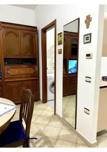 a bathroom with a mirror and a washing machine at Grace's Blue corner in Marconia