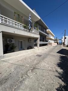 a building with a flag on the side of it at Makridakis apartments in Rethymno