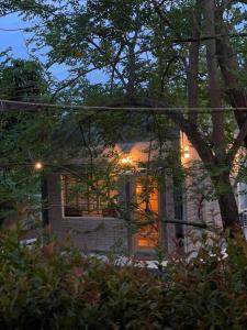 a house with lights on the front of it at Quiet Page CNX in Ban Phae Buak Ha