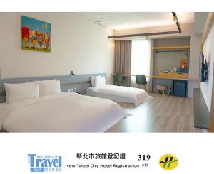 a hotel room with two beds and a desk at Thinker Hotel in Yingge