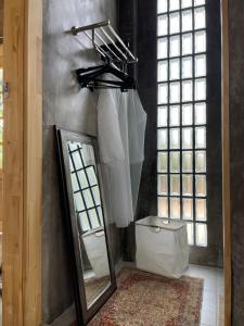 a mirror in a room with white umbrellas at Quiet Page CNX in Ban Phae Buak Ha +18 photos