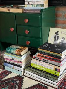 a stack of books sitting next to a dresser at Quiet Page CNX in Ban Phae Buak Ha
