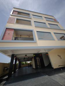 a large white building with a lot of windows at PVR Grand in Tirupati