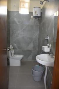 a bathroom with a sink and a toilet at PVR Grand in Tirupati