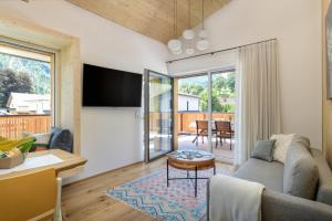 a living room with a couch and a table at Gratzenthal Boutique Apartments in Hollenstein an der Ybbs