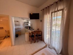 a kitchen with a table and a kitchen with a window at Explorer's Rest in Argassi