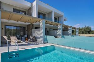 a house with a swimming pool in front of a house at Bella Terra Natura in Roda