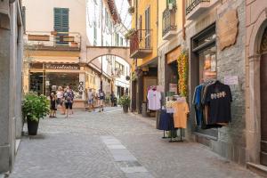 a street with a group of people walking down a street at Casa Sole Porlezza in Porlezza